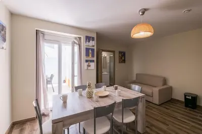 a dining room with a table and a living room at LovelyStay - Sweet Escape I - Terrace in Quarteira