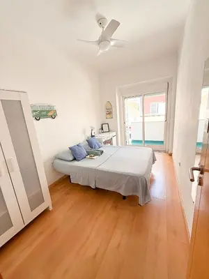 a bedroom with a bed and a ceiling fan at Surf Vibe Guest House in Faro