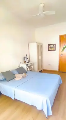 a large blue bed in a room with a ceiling at Surf Vibe Guest House in Faro