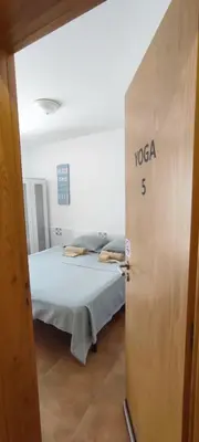 a bedroom with a bed in a room with a door at Surf Vibe Guest House in Faro