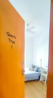 an orange door in a room with a bed at Surf Vibe Guest House in Faro