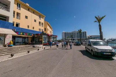 a street with a van parked next to a building at LovelyStay - Two Bedroom Duplex at Vilamoura Marina in Vilamoura