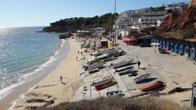 a beach with a bunch of boats on the sand at SOMAR Torre de Medronheira OLHOS DE AGUA ALBUFEIRA in Olhos de Água