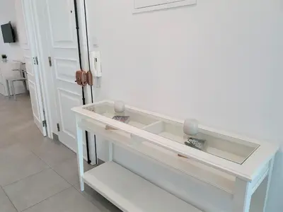 a white counter top in a room with a door at Lote 1 Aconchegante in Quarteira