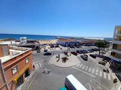 an aerial view of a parking lot next to the beach at T2 Gaveto- Frente Mar, Wifi, Aconchegante & Familiar in Quarteira