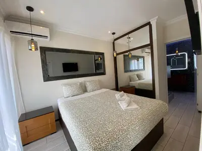 a small bedroom with a bed and a mirror at AL MMaria in Faro
