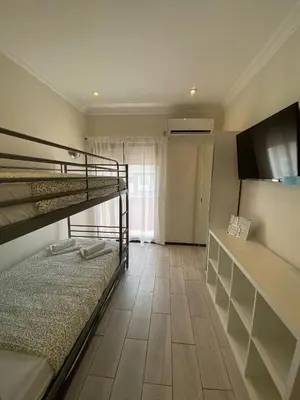 a bedroom with a bunk bed and a television at AL MMaria in Faro