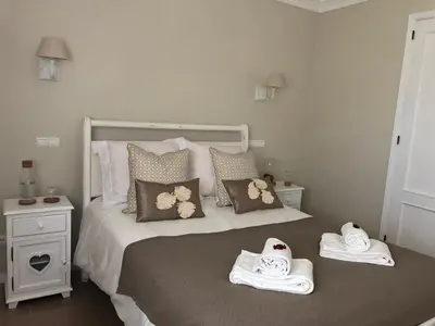 a bedroom with a bed with towels on it at Dream House - Condominio com piscina aquecida e propriedade com 5 bicicletas incluindo 1 eletrica in Albufeira