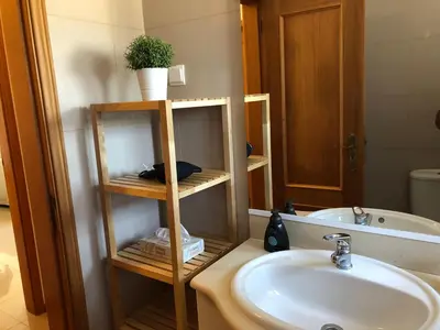 a bathroom with a sink and a toilet and a mirror at Dream House - Condominio com piscina aquecida e propriedade com 5 bicicletas incluindo 1 eletrica in Albufeira