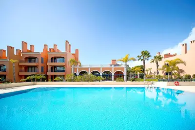 a large swimming pool in front of a building at AL - Apartamento Vila Sol F5 AH in Quarteira