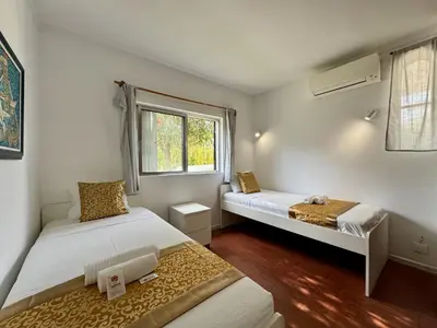 two beds in a room with red and white at Vilamoura Ocean Villa with Pool by Homing in Vilamoura