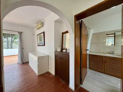 a bathroom with two sinks and a toilet and a window at Vilamoura Ocean Villa with Pool by Homing in Vilamoura