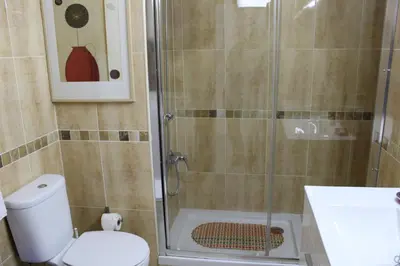 a bathroom with a shower with a toilet and a sink at Naturmar Praia in Albufeira