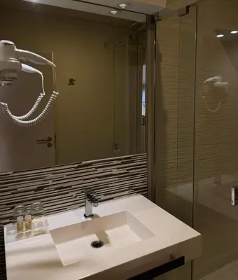 a bathroom with a sink and a mirror at Aqua Ria Boutique Hotel in Faro