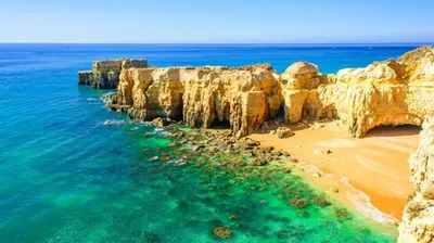 a view of a beach with rocks and the ocean at Cozy apartment in Albufeira 76 m² with lovely terrace in Albufeira