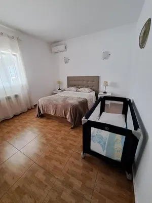a kitchen with white cabinets and a washer and dryer at Villa Claramar in Albufeira