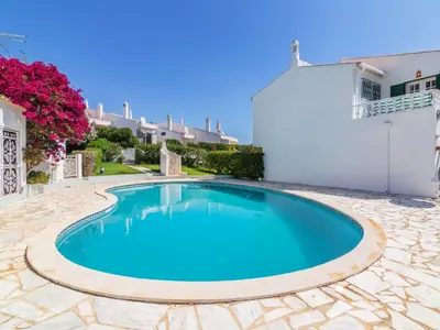 a swimming pool in a yard with a white house at Holiday Home Roberts by Interhome in Albufeira