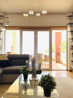 a living room with a couch and a table at Golf Mar Village By Vilamoura Sun- Vista Golfe in Vilamoura