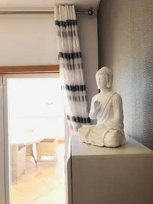 a statue sitting on a box in a room at Golf Mar Village By Vilamoura Sun- Vista Golfe in Vilamoura