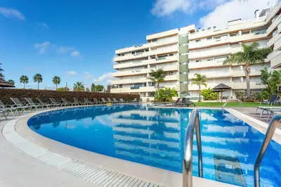 a swimming pool in front of a building at Walkable Marina Vilamoura Aquamar 513 VilamouraSun in Quarteira