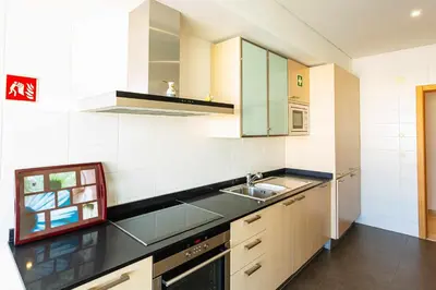 a kitchen with a sink and a stove at Walkable Marina Vilamoura Aquamar 513 VilamouraSun in Quarteira