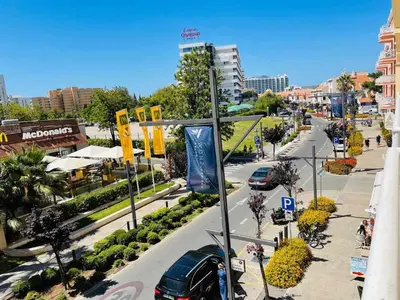 a city street with cars parked on the road at Vilamoura Center - Near Marina By Vilamoura Sun in Quarteira