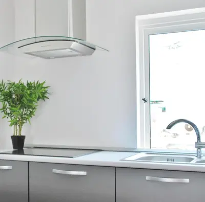 a kitchen with a sink and a potted plant at Peneco Albufeira GuestHouse in Albufeira