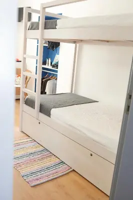 a bunk bed in a room with a rug at Peneco Albufeira GuestHouse in Albufeira