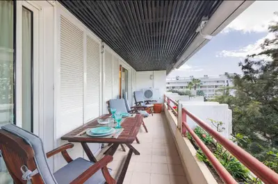 a porch with a table and chairs on a balcony at Apartamento dentro da Marina de Vilamoura in Vilamoura