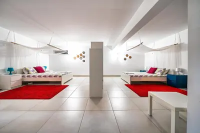a white room with two beds and red rug at Townhouse 3 Bedroom Townhouse Olhos de Agua Communal pool AT03 in Olhos de Água