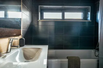 a bathroom with a sink and a tub and a window at Townhouse 3 Bedroom Townhouse Olhos de Agua Communal pool AT03 in Olhos de Água