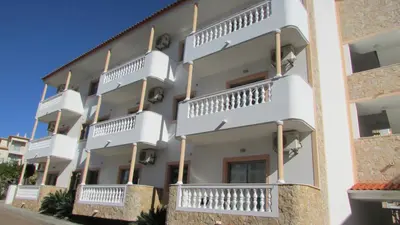 a building with white balconies on the side of it at Apartamento - 2 a 4 Pessoas- Piscina in Olhos de Água