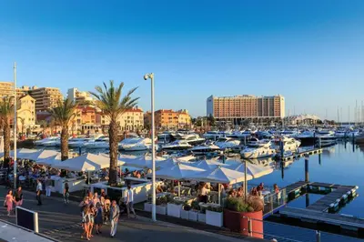 a marina with many boats and people walking around at Marina Vilamoura Aquamar 203 By Vilamoura Sun in Quarteira