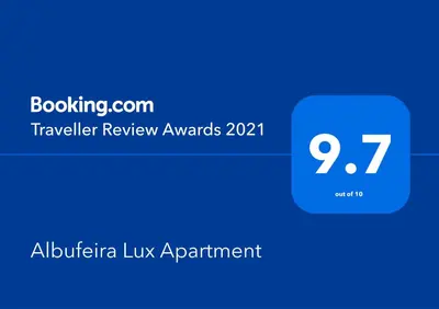 a bedroom with a large white bed with two pillows at Albufeira Lux Apartment in Albufeira