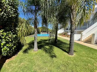 a pool of water in front of a building at Albufeira Lux Apartment in Albufeira