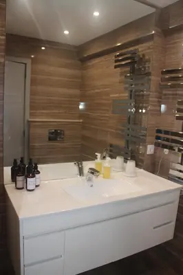 a bathroom with a white sink and a mirror at Casa do Largo in Faro