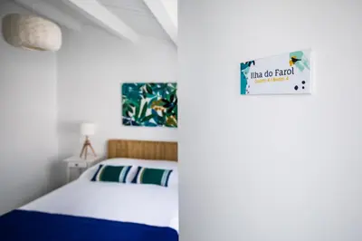 a bedroom with a bed and a picture on the wall at Faro Guest House in Faro
