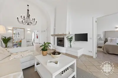 a living room with a couch and a fireplace at Casa Julia - Dunas Douradas in Faro
