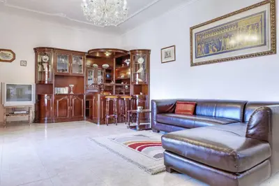 a living room with a leather couch and a tv at Villa Antao in Guia