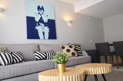 a living room with a couch and a table at Stylish Center Apartment Vilamoura in Vilamoura