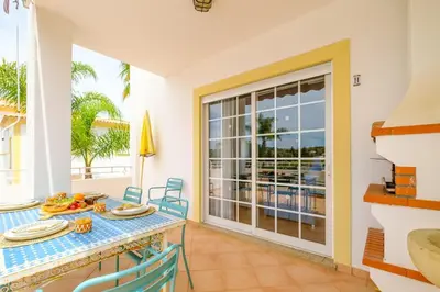 a dining room with a table and a view of the ocean at Villa Isabella in Albufeira