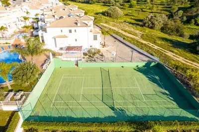 an overhead view of a tennis court with a tennis court at Villa Isabella in Albufeira