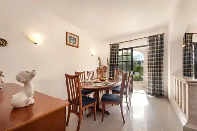 a patio with a table and an outdoor oven at Spacious 4 bedroom villa, private pool, free air conditioning and wifi in Quarteira