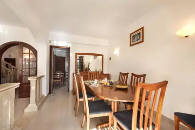 a balcony with a view of a house at Spacious 4 bedroom villa, private pool, free air conditioning and wifi in Quarteira