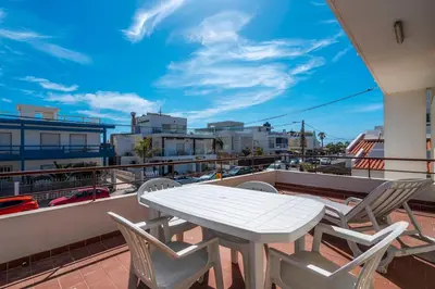 a white table and chairs on a balcony at Sundance Beach House in Faro