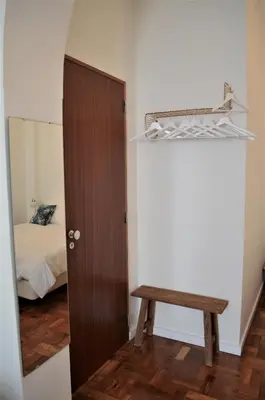 a room with a door and a bench and a bed at Casa aOrta Downtown in Faro