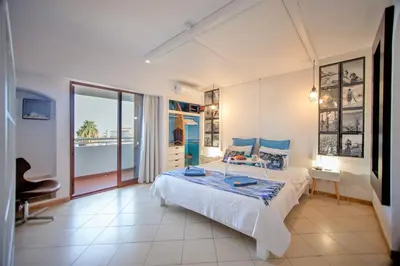 a bedroom with a bed and a view of the ocean at Love Albufeira - Center, walk to the beach, Old Town, Oura Strip, top location in Albufeira