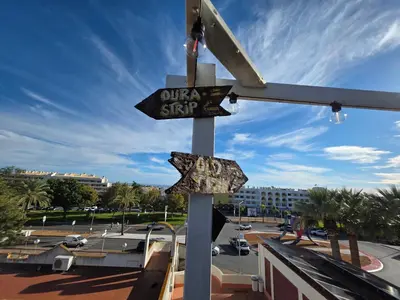 a street sign on a pole in a parking lot at Love Albufeira - Center, walk to the beach, Old Town, Oura Strip, top location in Albufeira
