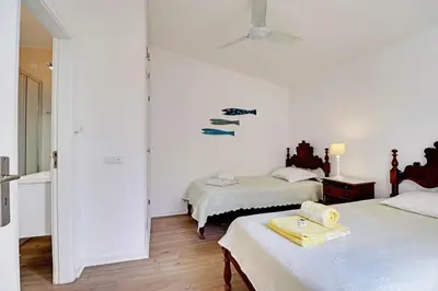 a bedroom with two beds and a ceiling at Vilamoura Golf Villa 1 With Pool by Homing in Vilamoura