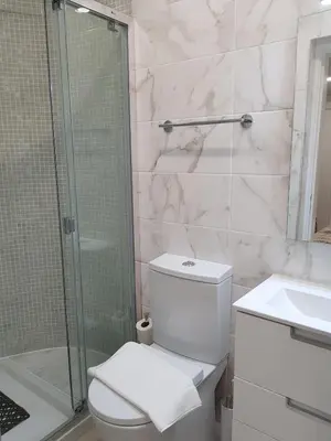 a bathroom with a toilet and a shower and a sink at Forte Beach- Albufeira in Albufeira